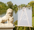 Stone lion statue in front of a wedding invitation sign with floral decorations by a lake.