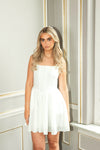Woman wearing a white dress in an elegant interior setting